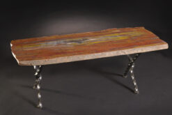 Exceptional petrified wood table featuring quartz pockets and amethyst inclusions with a rough iron base for a rustic and elegant look.