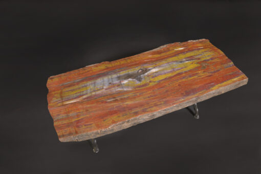 Exceptional petrified wood table featuring quartz pockets and amethyst inclusions with a rough iron base for a rustic and elegant look.