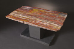 Extremely colorful petrified wood table with a quartz pocket on a custom iron base